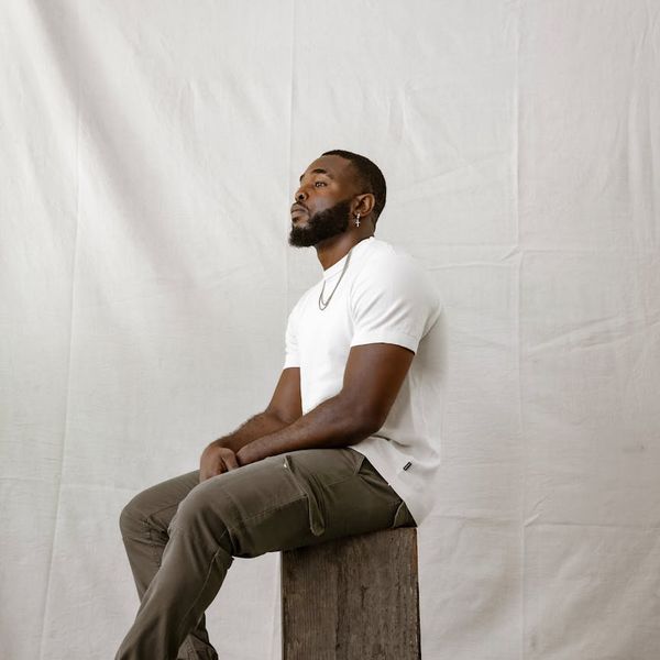 Man sitting in a calm, meditative pose after a workout, looking relaxed.