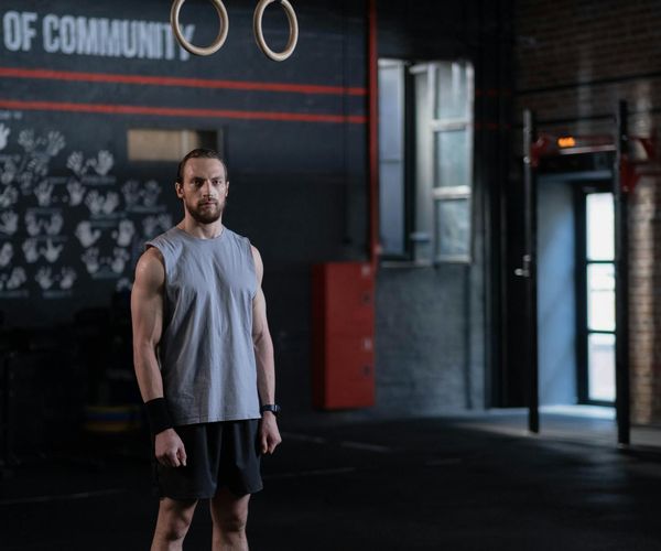 Three men of different ages and builds looking motivated in a training space.